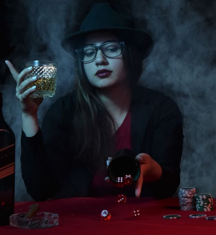 Menu Woman with drink playing dice amidst casino smoke, evoking a mysterious nightlife vibe.