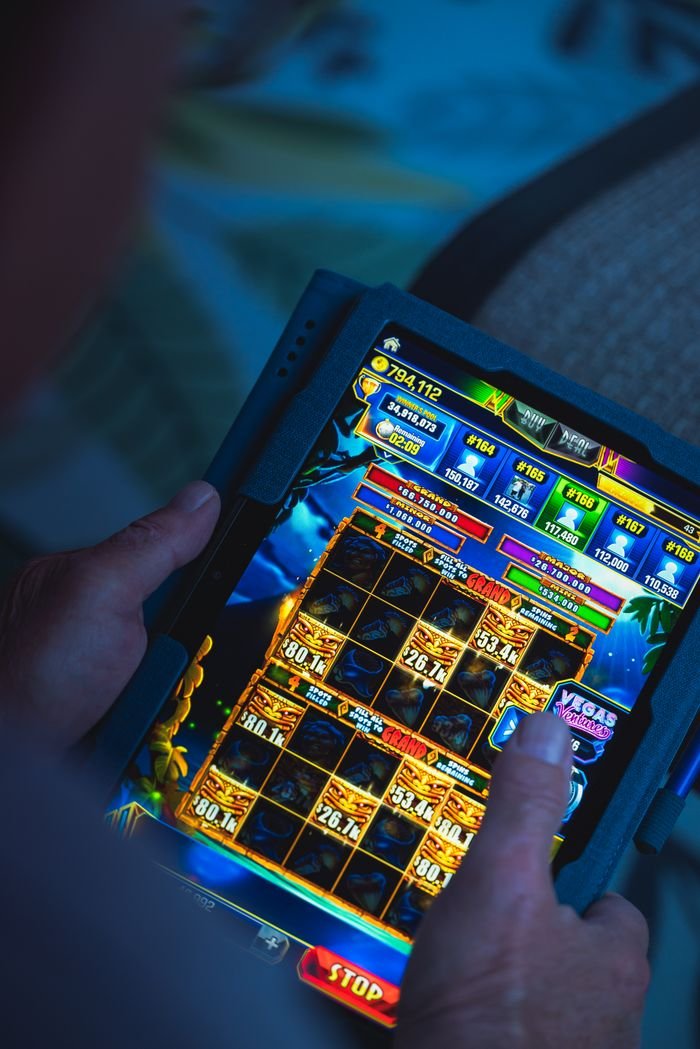 Menu Person playing a mobile gaming app on a tablet, focused on fun and entertainment.