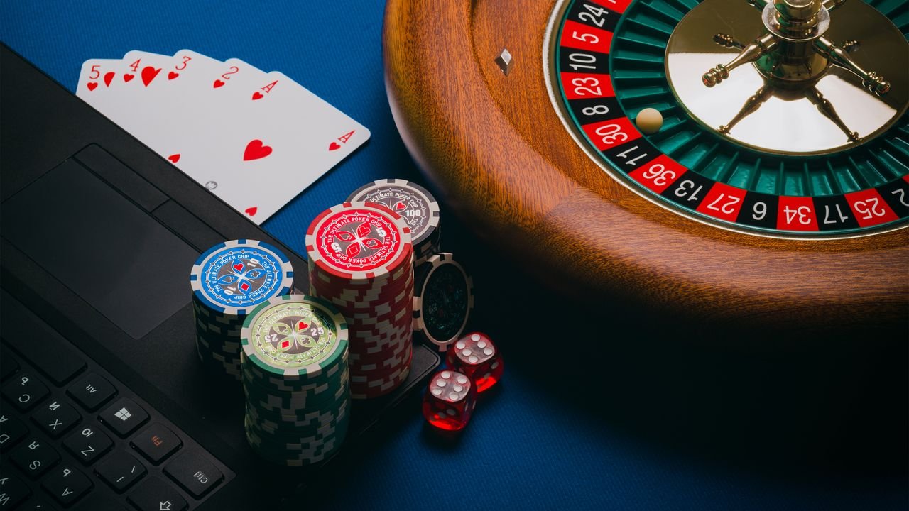 Menu Close-up of a roulette table, poker chips, and playing cards depicting casino culture.