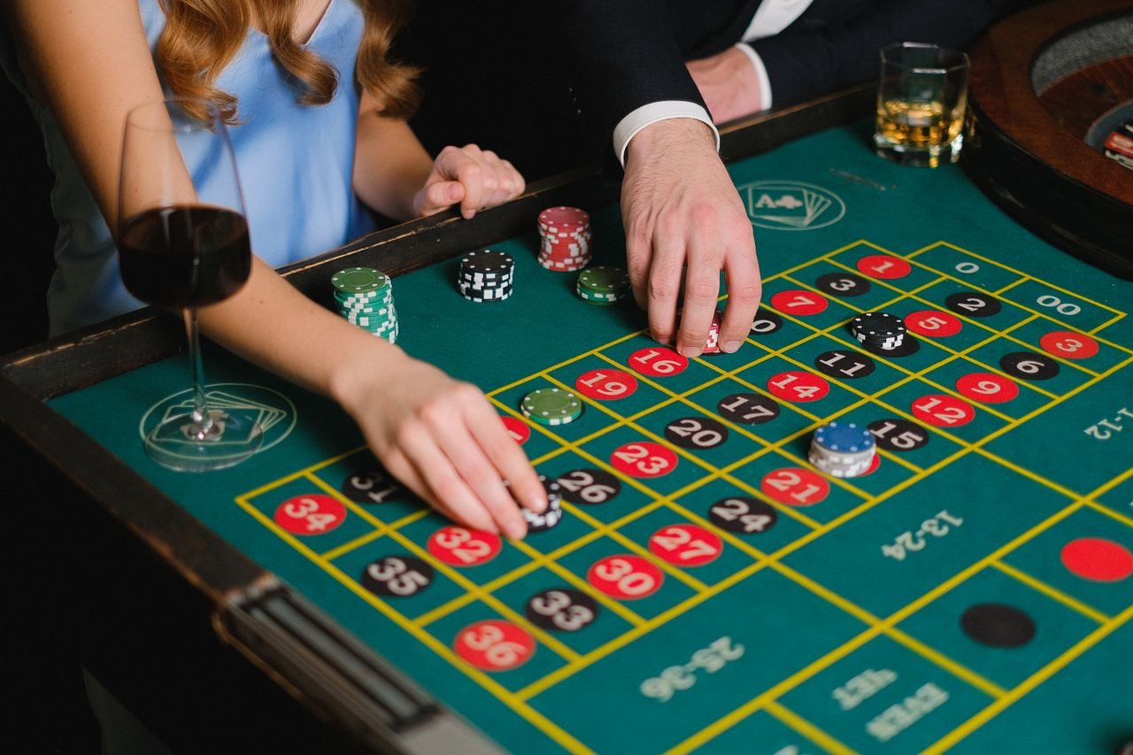 Crafting Captivating Headlines: Your awesome post title goes here Two people playing roulette at a casino table, placing bets for a thrilling night.